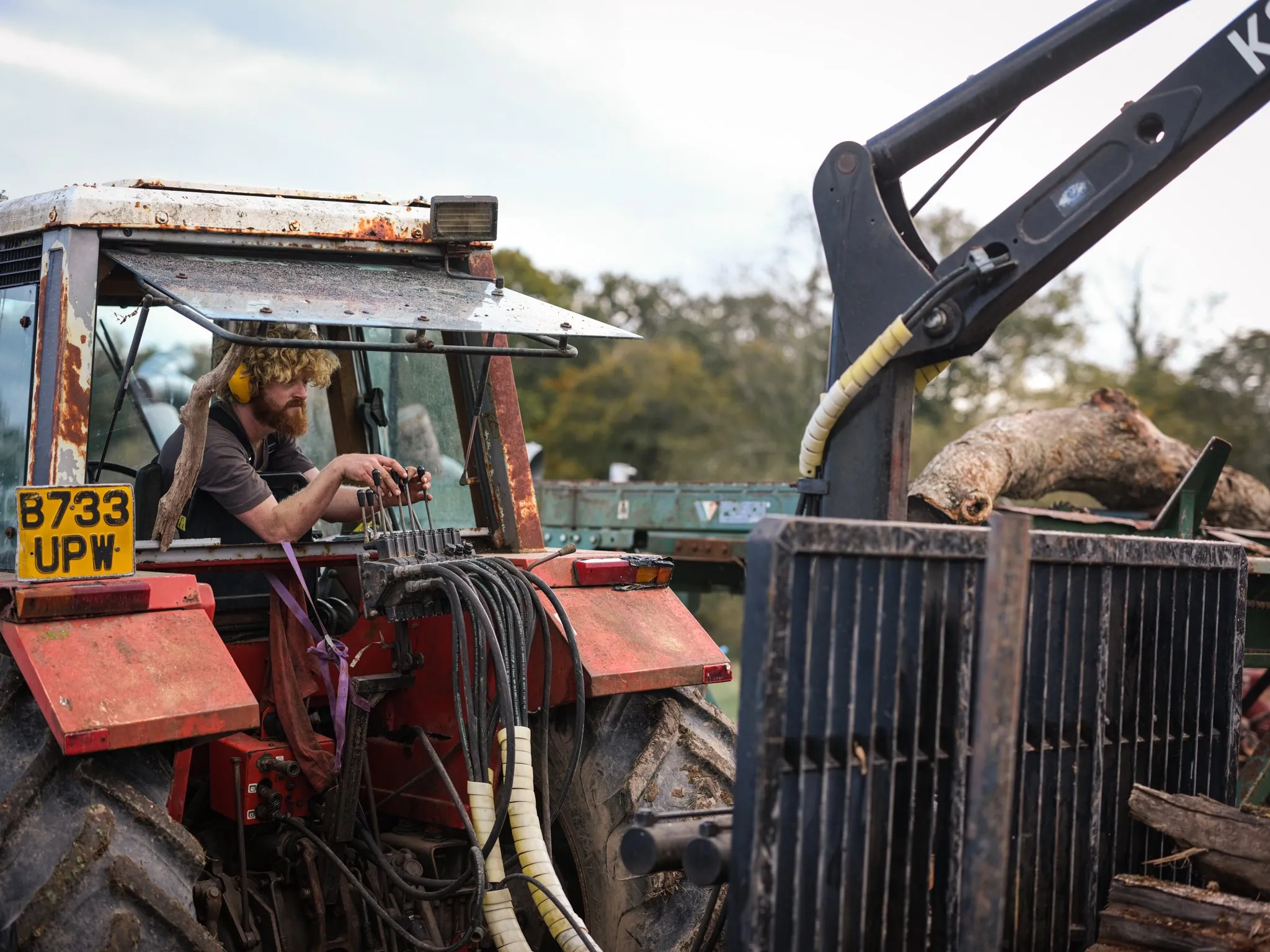 One of the team operating the tractor with a grapple loader