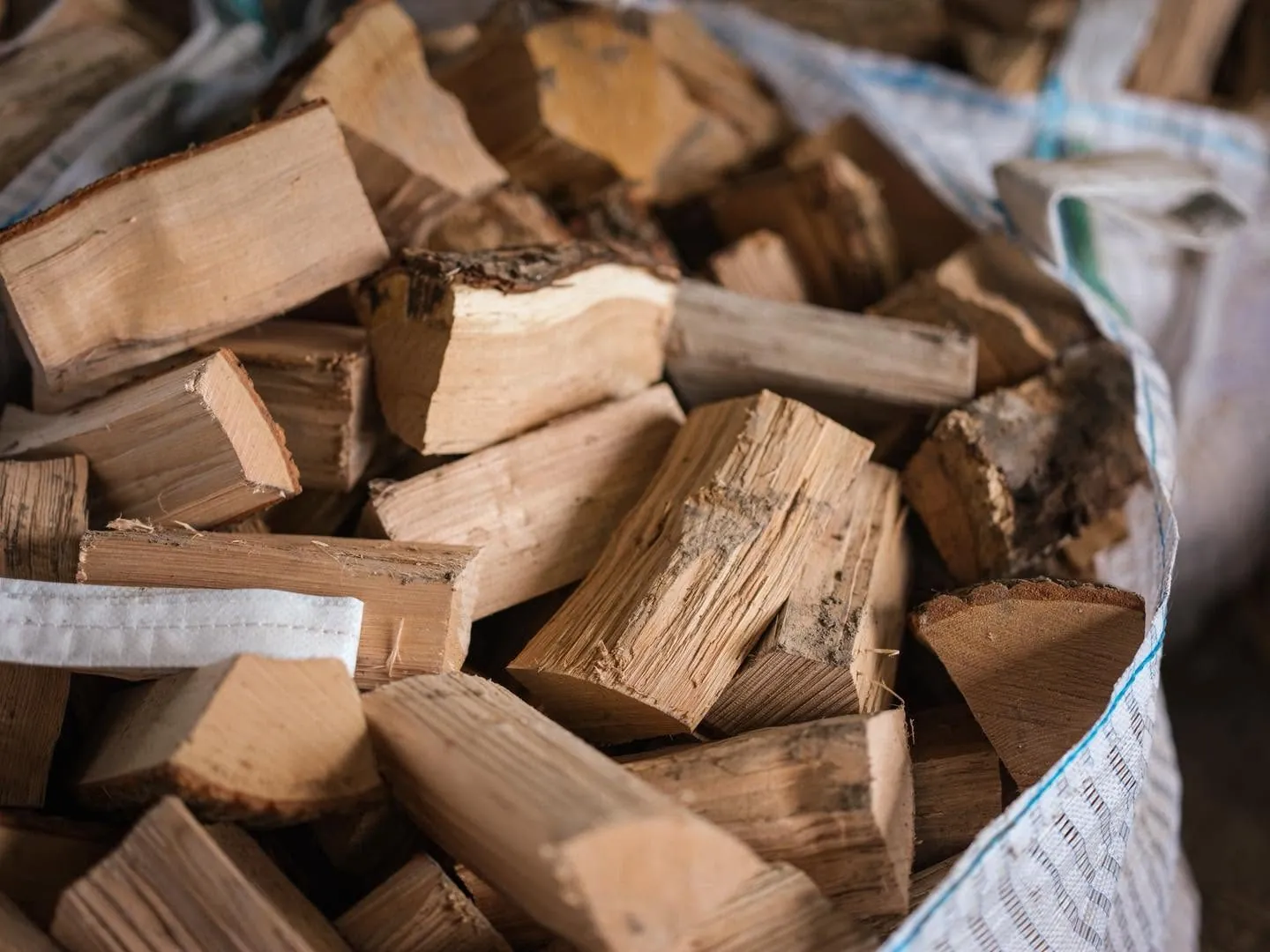 A close up view of split logs packed inside a bag.