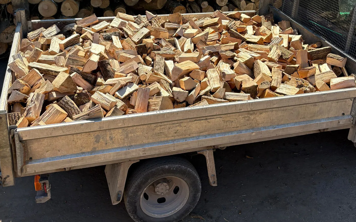 A full tipper load of split seasoned hardwood on the truck at our West Sussex yard